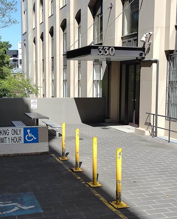 A building with a sign and a bench
AI-generated content may be incorrect.